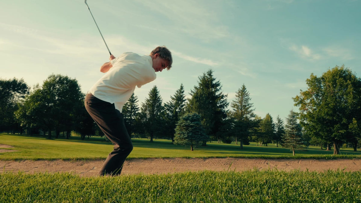 Golfeur qui frappe dans une fosse de sable